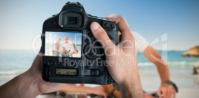 Composite image of cropped image of hands holding camera