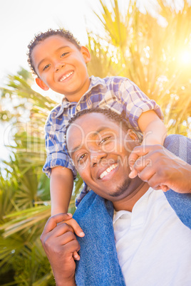 Mixed Race Son and African American Father Playing Piggyback Out