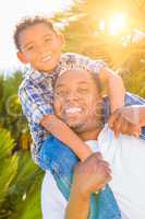Mixed Race Son and African American Father Playing Piggyback Out