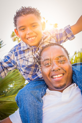 Mixed Race Son and African American Father Playing Piggyback Out