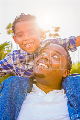 Mixed Race Son and African American Father Playing Piggyback Out