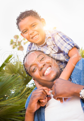 Mixed Race Son and African American Father Playing Piggyback Out