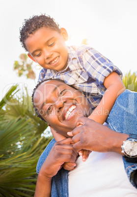 Mixed Race Son and African American Father Playing Piggyback Out