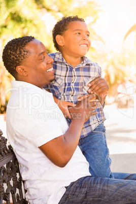 Mixed Race Son and African American Father Playing Outdoors Toge