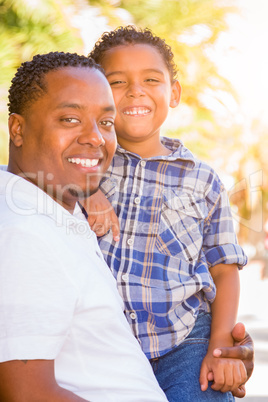 Mixed Race Son and African American Father Playing Outdoors Toge