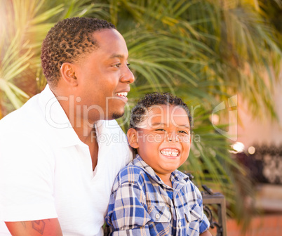 Mixed Race Son and African American Father Playing Outdoors Toge