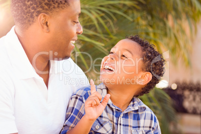 Mixed Race Son and African American Father Playing Outdoors Toge