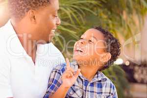 Mixed Race Son and African American Father Playing Outdoors Toge
