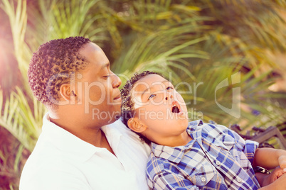 Mixed Race Son and African American Father Playing Outdoors Toge