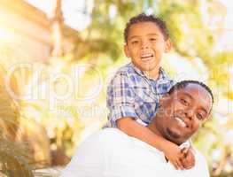 Mixed Race Son and African American Father Playing Outdoors Toge