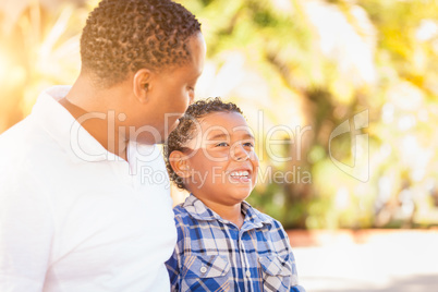 Mixed Race Son and African American Father Playing Outdoors Toge