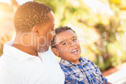 Mixed Race Son and African American Father Playing Outdoors Toge