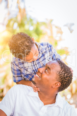 Mixed Race Son and African American Father Playing Outdoors Toge