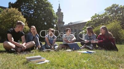 Group of students chatting on campus lawn