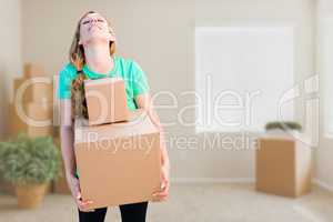 Tired Young Adult Woman Holding Moving Boxes In Empty Room In A