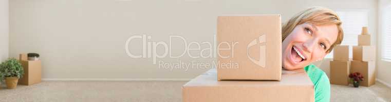 Banner of Happy Young Adult Woman Holding Moving Boxes In Empty