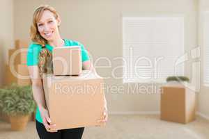 Happy Young Adult Woman Holding Moving Boxes In Empty Room In A