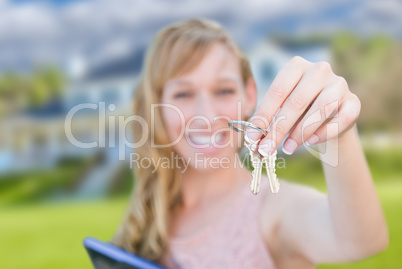 Excited Woman Holding House Keys in Front of Nice New Home.