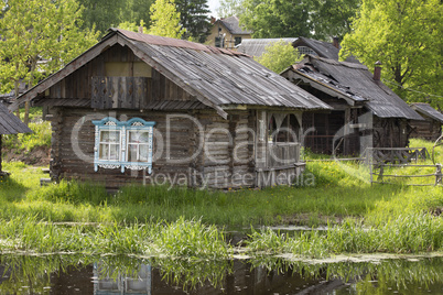 An ancient village, wooden houses on the river bank