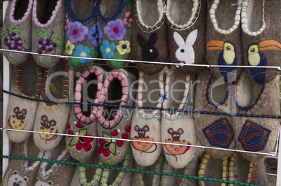 Handmade wool slippers in a street market.