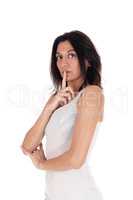 Woman holding finger over mouth.