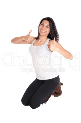 Woman kneeling with thumps up.