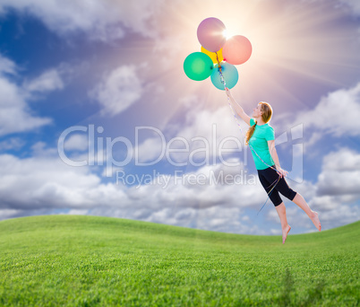 Young Girl Being Carried Up and Away By Balloons That She Is Hol