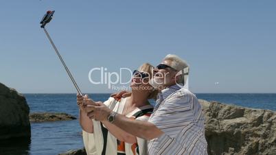 Mature Couple Taking Selfie On Smartphone At Beach Resort First Time