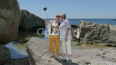 Loving Mature Couple Taking Selfie On Smartphone At Beach Resort, First Time