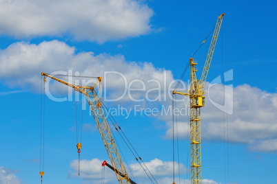 Two yellow construction cranes