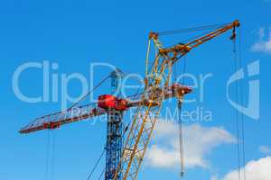 Two construction cranes