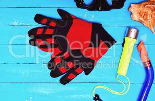 Red gloves for diving among other sports equipment