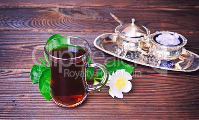 Black tea in a clear glass glass with a handle