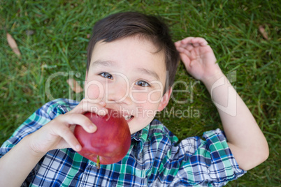 Mixed Race Chinese and Caucasian Young Boy With Apple Relaxing O