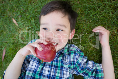 Mixed Race Chinese and Caucasian Young Boy With Apple Relaxing O