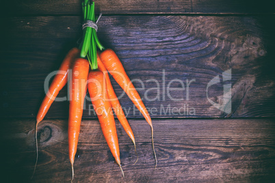 Bunched fresh carrots on a wooden table