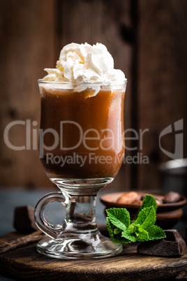 Iced cocoa drink with whipped cream, cold chocolate beverage, coffee frappe on dark background