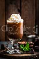 Iced cocoa drink with whipped cream, cold chocolate beverage, coffee frappe on dark background