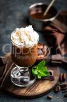 Iced cocoa drink with whipped cream, cold chocolate beverage, coffee frappe on dark background