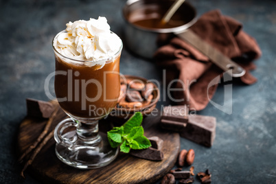 Iced cocoa drink with whipped cream, cold chocolate beverage, coffee frappe on dark background