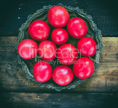Ripe red tomatoes on an iron plate