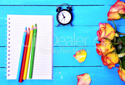 Empty notebook and colorful pencils
