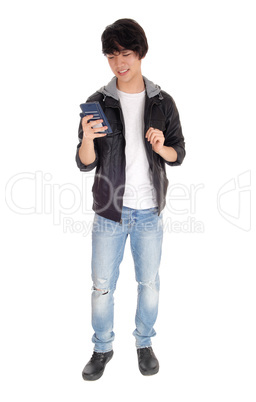 Asian teenager looking at his cellphone.