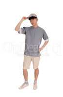 Happy Asian man standing in shorts.