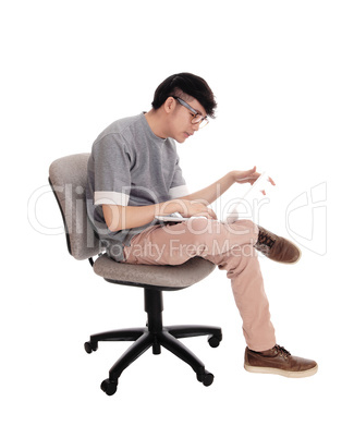 Asian man working at his laptop.