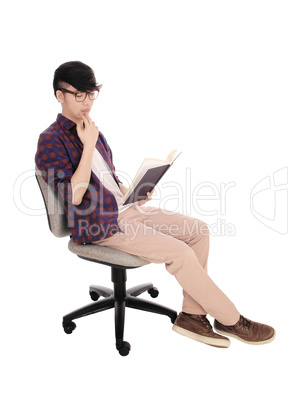Asian man reading a book.