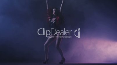 Beautiful Woman dancing on stage with flares and lights, Young Pretty Female dancing.