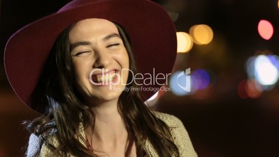 Portrait of joyful girl laughing in night street
