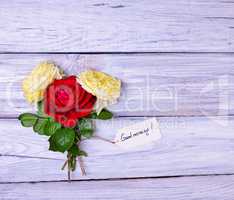 roses and a paper tag with an inscription good morning