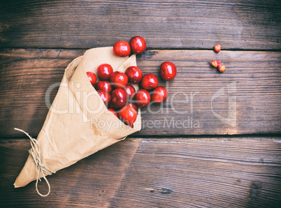 Ripe red cherry in a paper bag